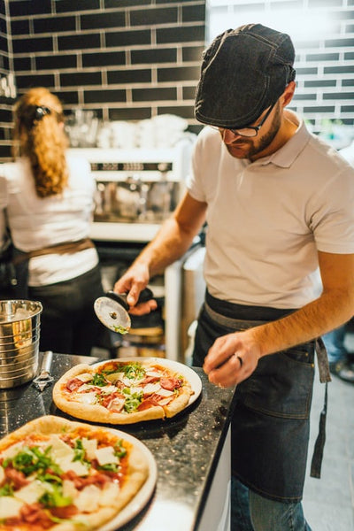 What temperature do commercial pizza ovens cook at?
